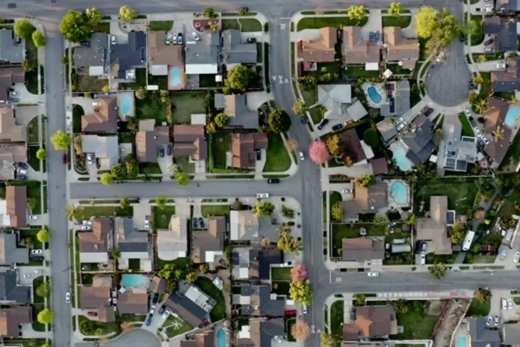 An aerial view of a suburban neighborhood with houses and streets.