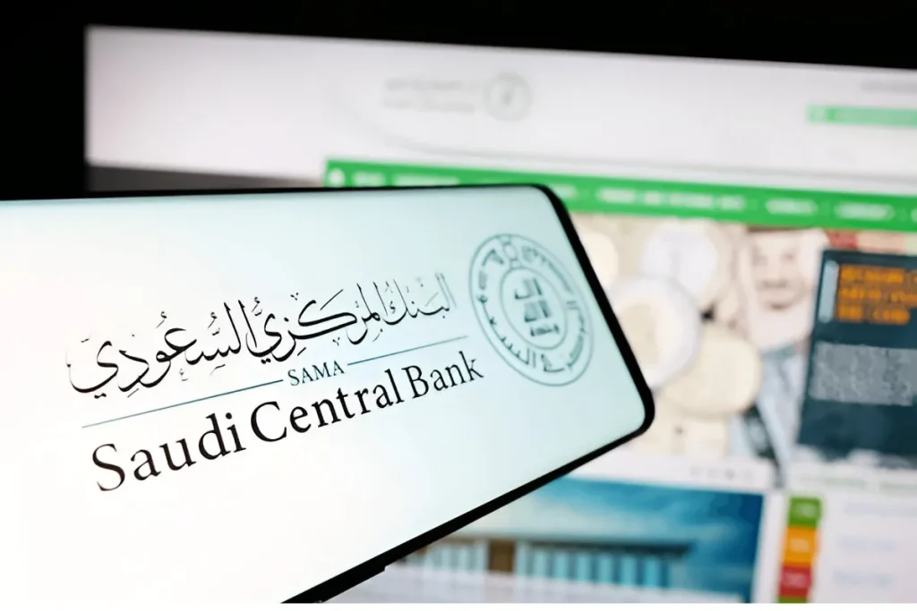 A close-up image of the Saudi Central Bank logo, representing the authority overseeing Saudi Arabia's financial policies and currency stability.