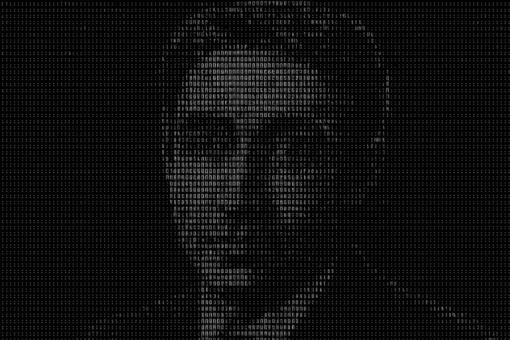 A monochromatic ASCII art portrait of a man’s face, composed of keyboard characters and symbols.